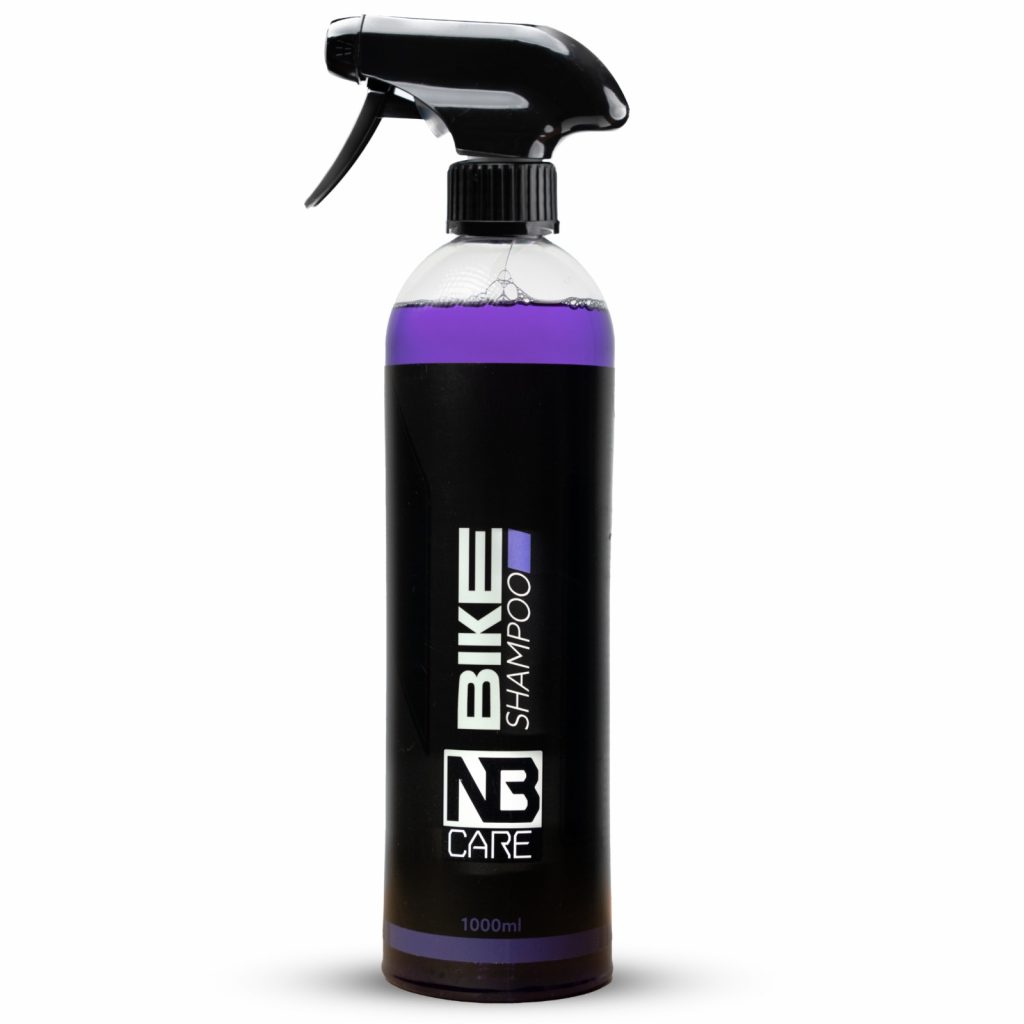 a purple spray bottle with a black label