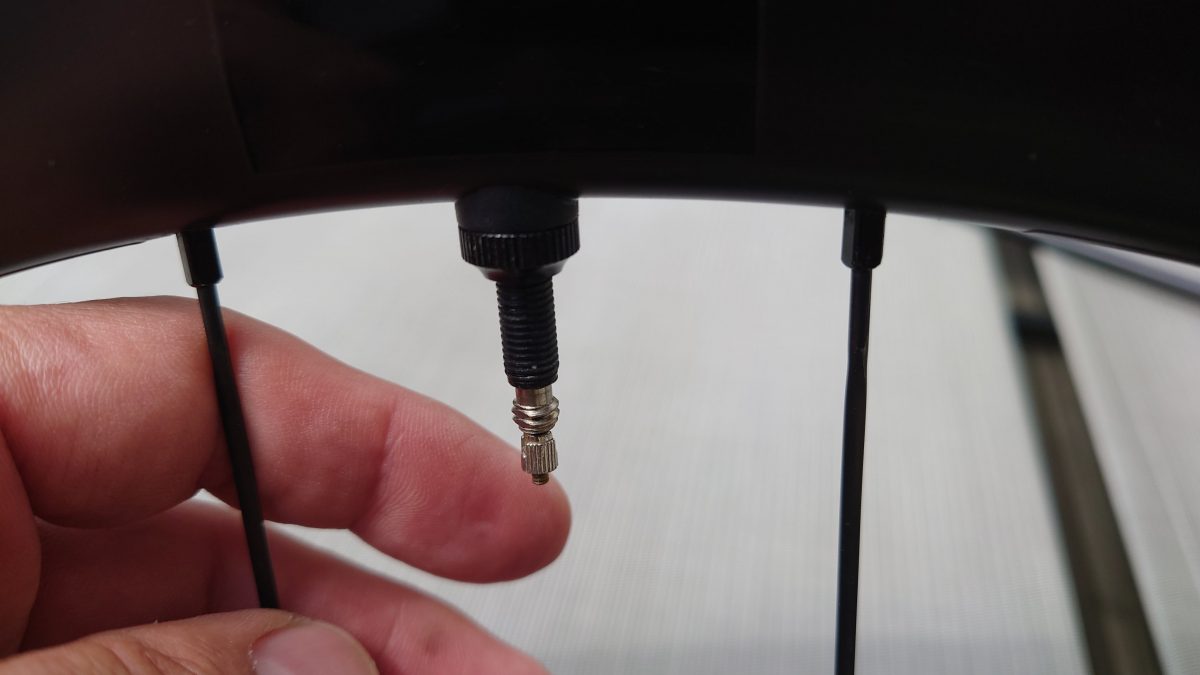 a close up of a hand holding a black tube