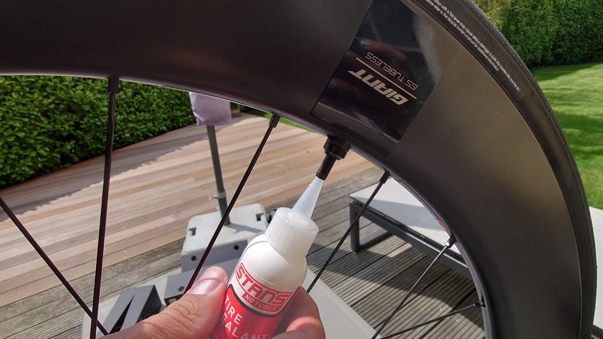 a hand holding a tubeless tire